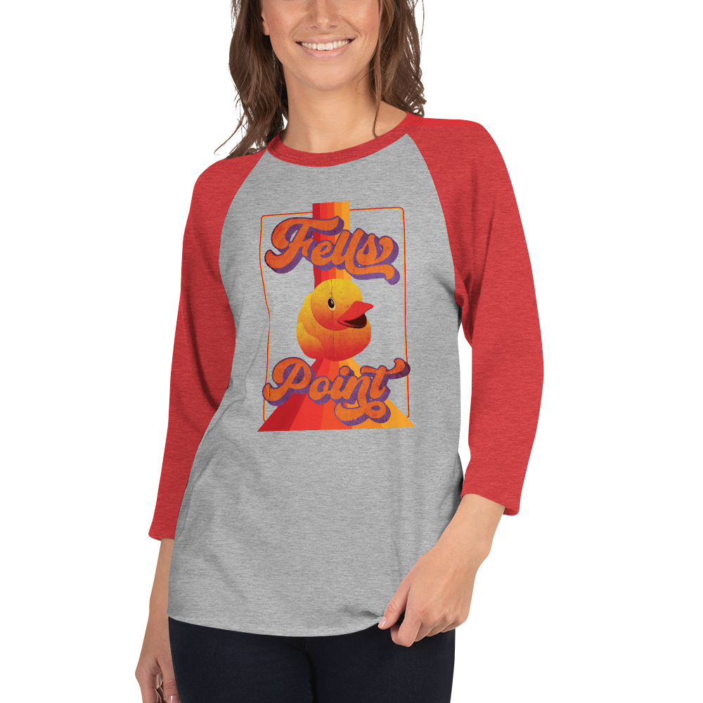 woman wearing a red sleeve, gray centered raglan shirt with a vintage 1970's design that says "Fells Point" and features a yellow rubber duck