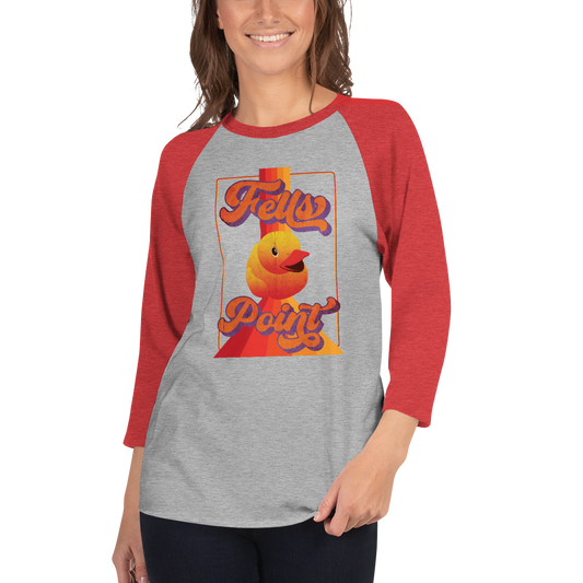 woman wearing a red sleeve, gray centered raglan shirt with a vintage 1970's design that says "Fells Point" and features a yellow rubber duck