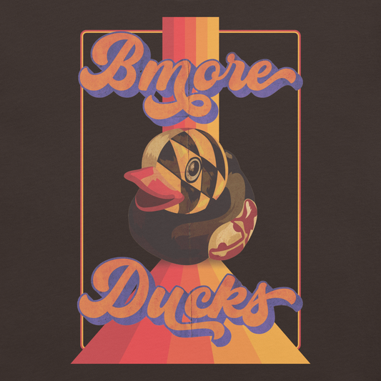 brown colored t-shirt with a vintage design that says "Bmore Ducks" and features a Maryland Flag rubber duck