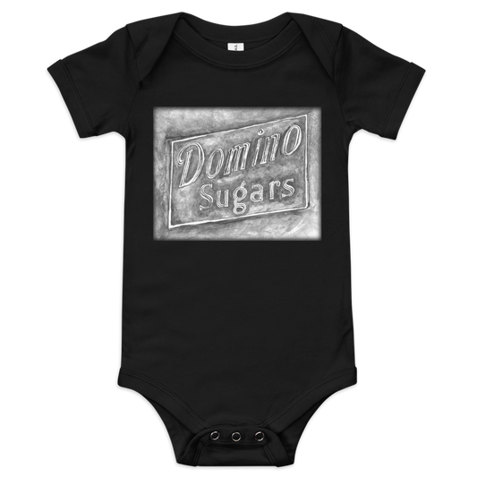 Picture of a black baby onesie with a printed image of a watercolor painting of the Domino Sugars sign painted on a map of Baltimore