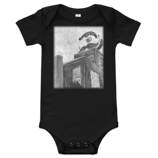 A picture of a black baby onesie with an printed image of Baltimore's Natty Boh tower painted on a map of the city