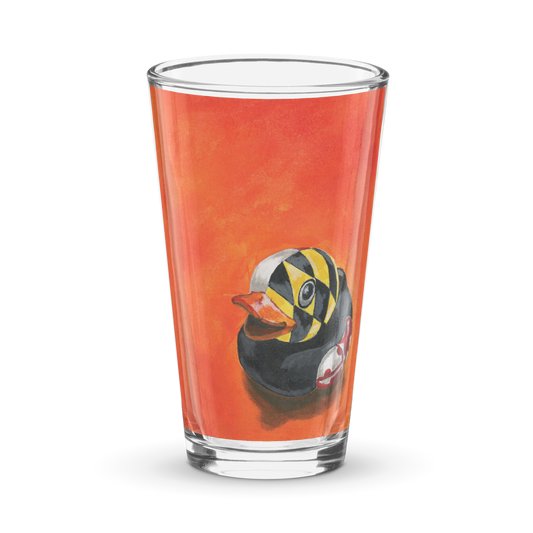 Pint glass with an image of a painted rubber duck with the Maryland flag overlay on an orange background