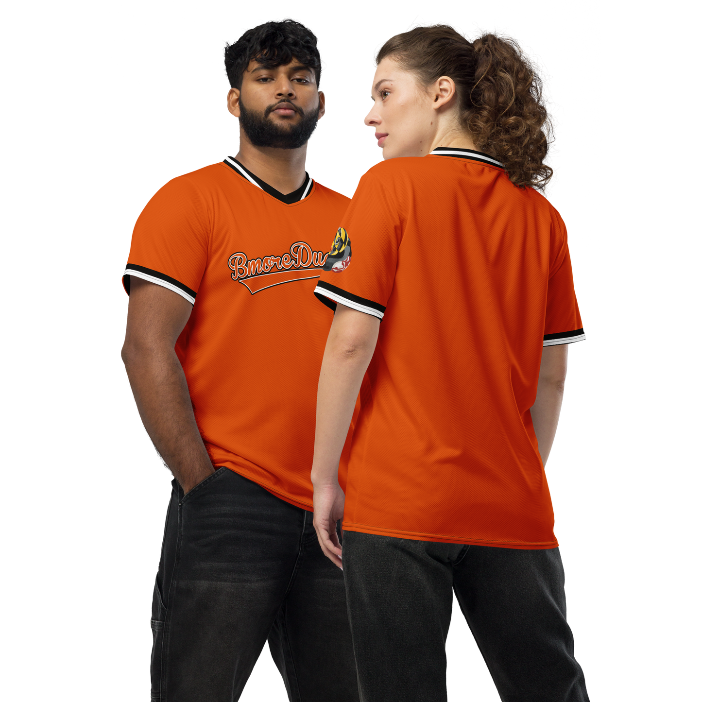 a couple modeling a orange BMORE DUCKS! baseball style jersey with script team name and logo of a rubber duck with Maryland state flag overlay