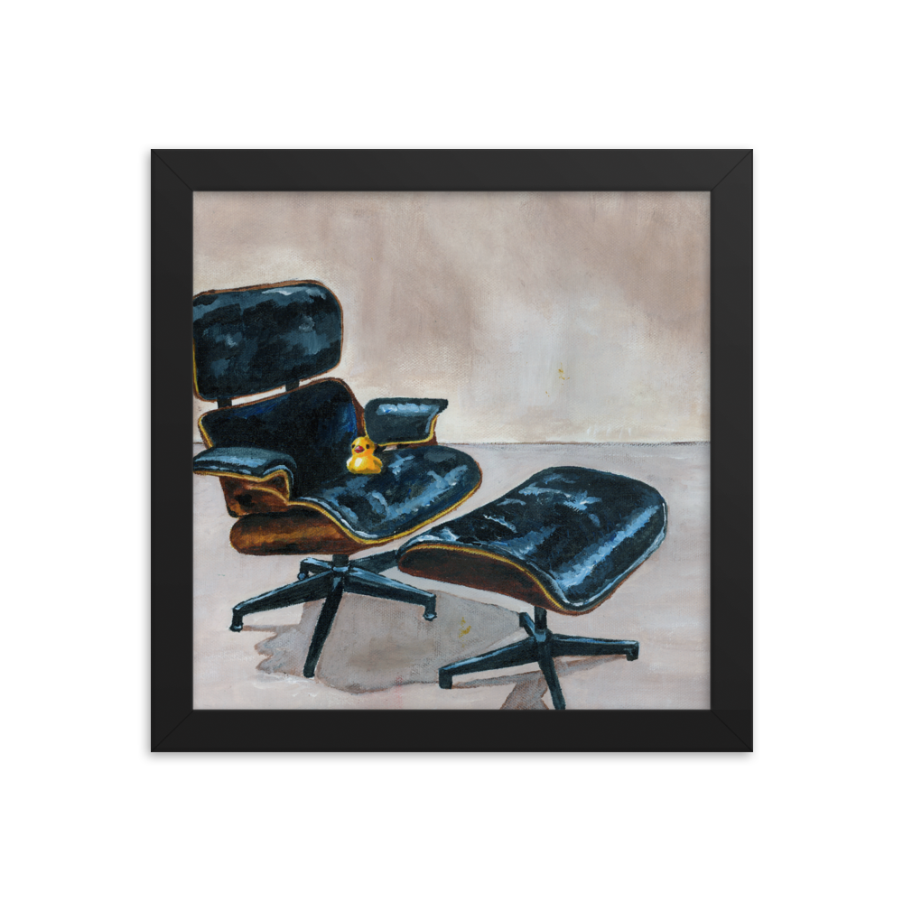 10x10 Framed print of a rubber duck sitting in a black Eames chair. Framed in black