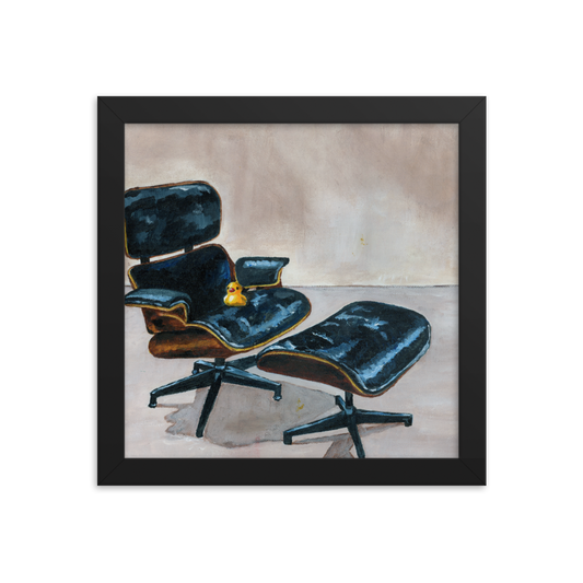 10x10 Framed print of a rubber duck sitting in a black Eames chair. Framed in black