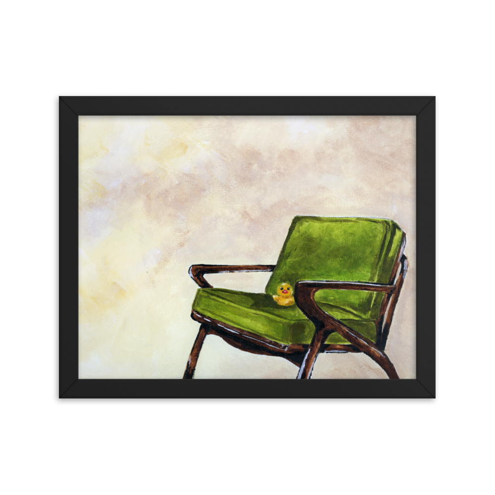 11x14 Framed print of a rubber duck sitting in a green mid century arm chair. Framed in black