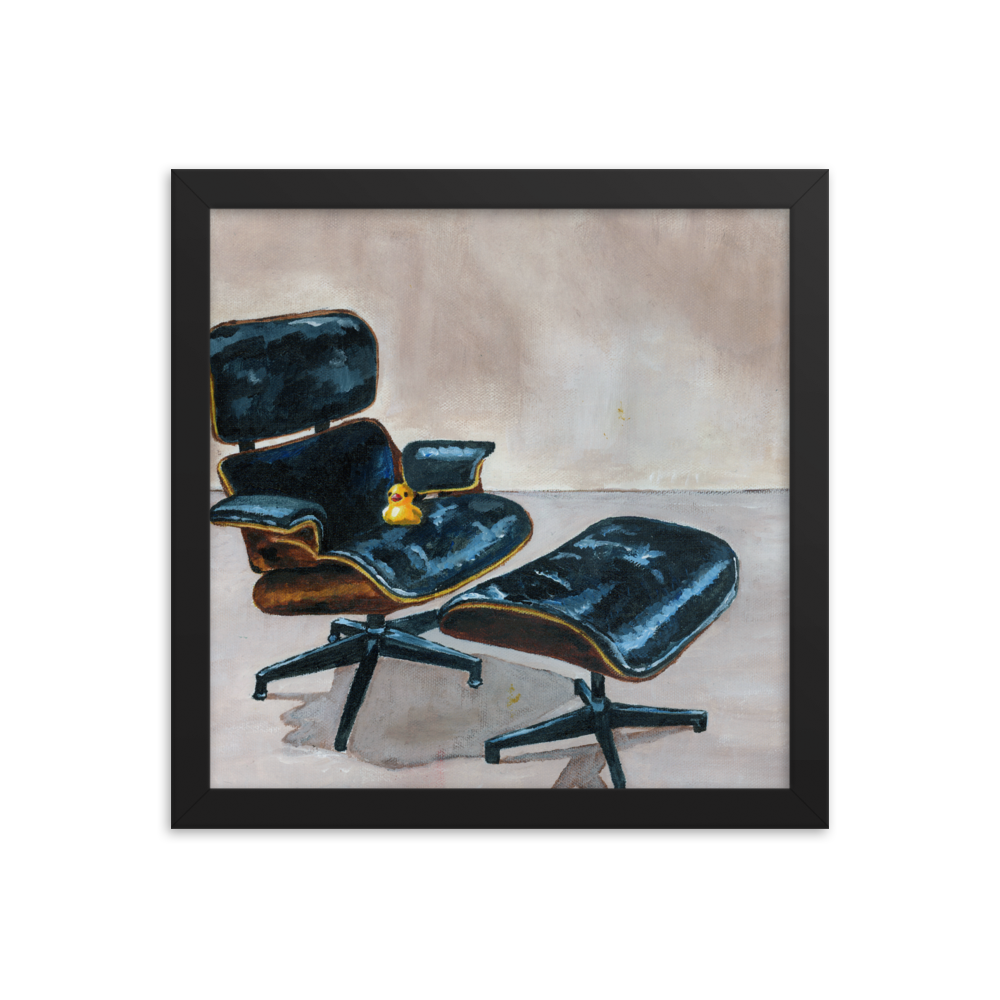 12x12 Framed print of a rubber duck sitting in a black Eames chair. Framed in black