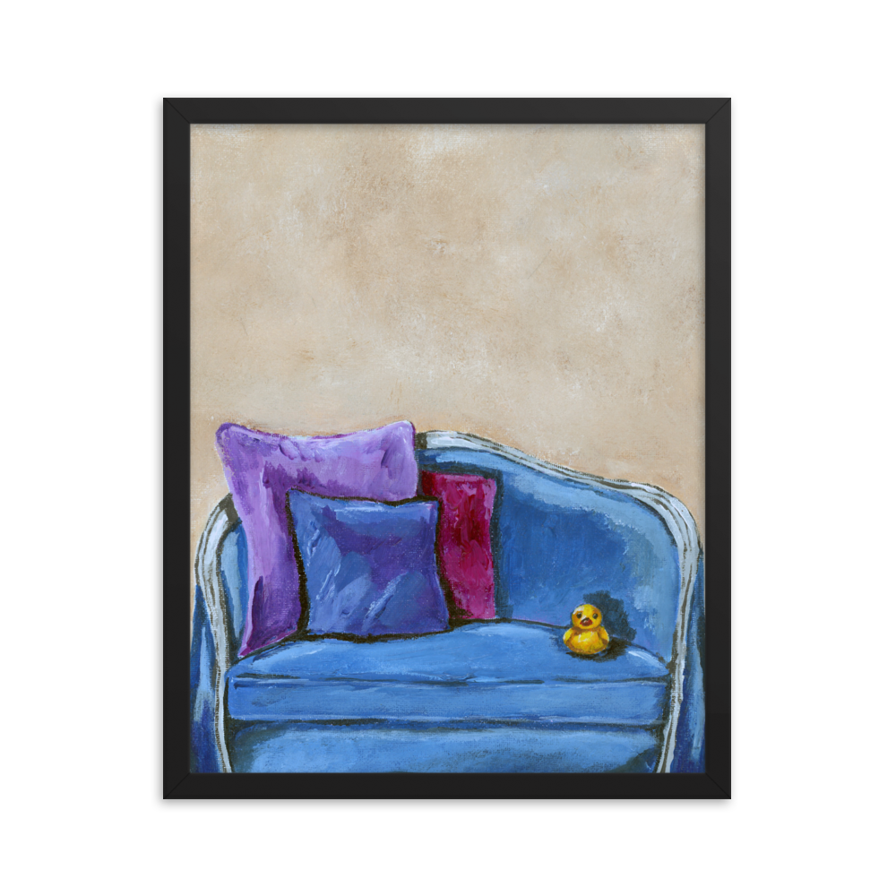 16x20 Framed print of a rubber duck sitting in a blue upholstered chair. Framed in black