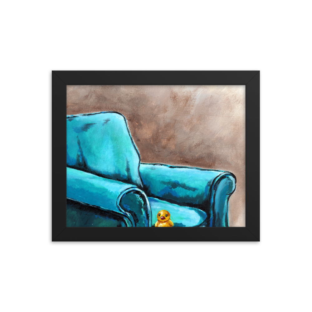 8x10 Framed print of a painting of a rubber duck sitting in a blue arm chair. Framed in black