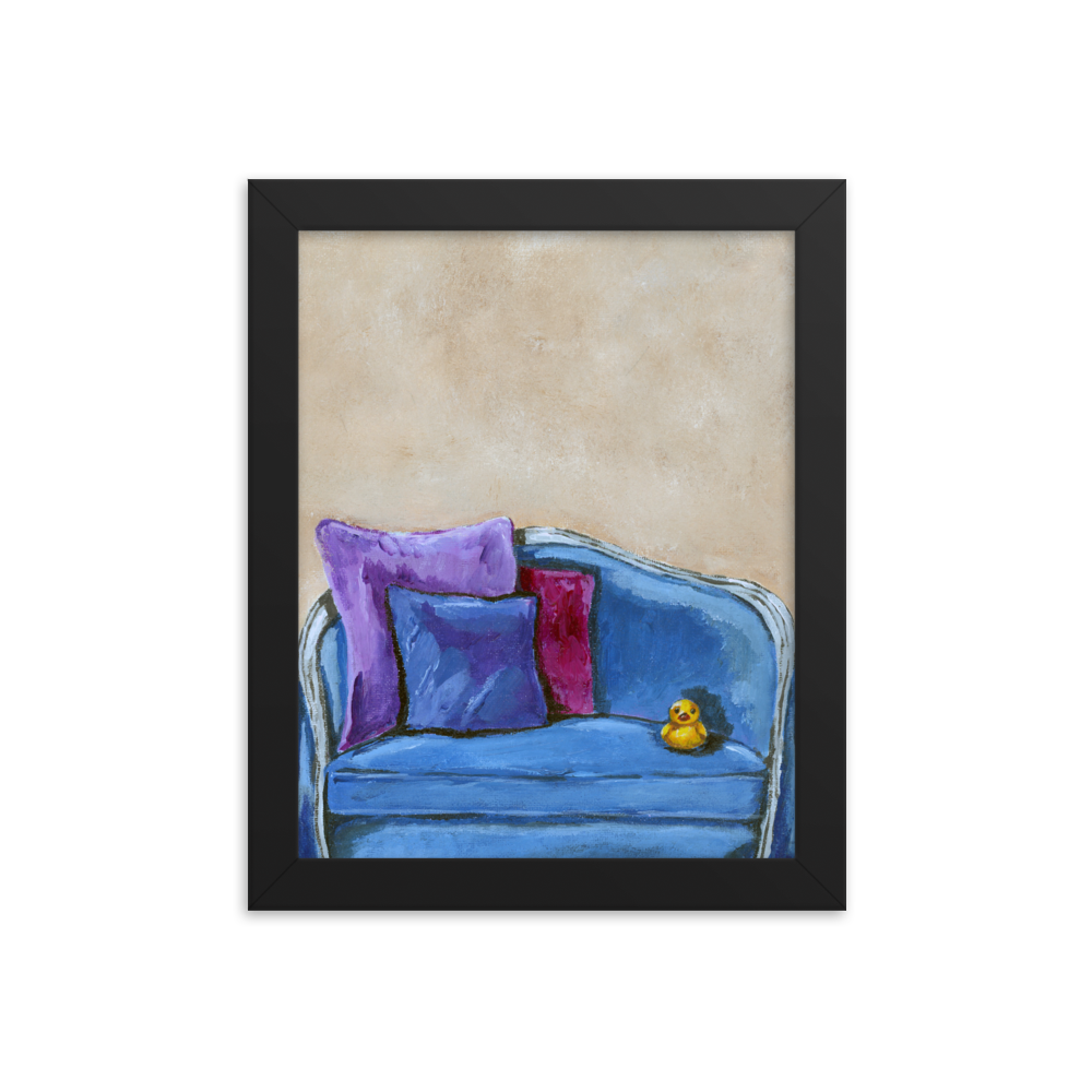 8x10 Framed print of a rubber duck sitting in a blue upholstered chair. Framed in black