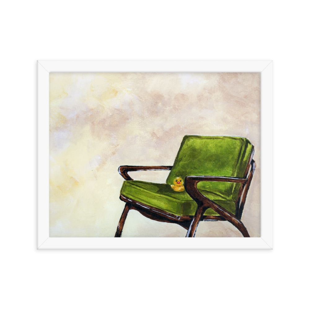 11x14 Framed print of a rubber duck sitting in a green mid century arm chair. Framed in white