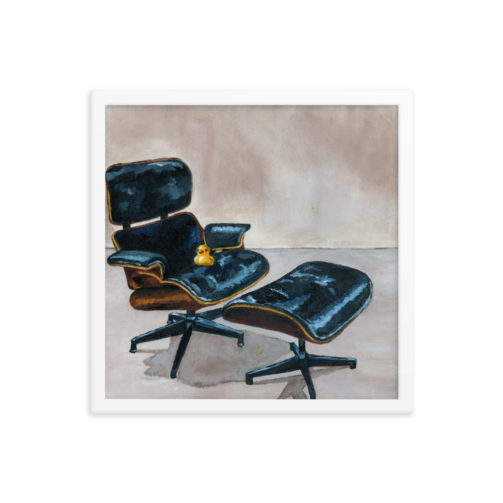 16x16 Framed print of a rubber duck sitting in a black Eames chair. Framed in white