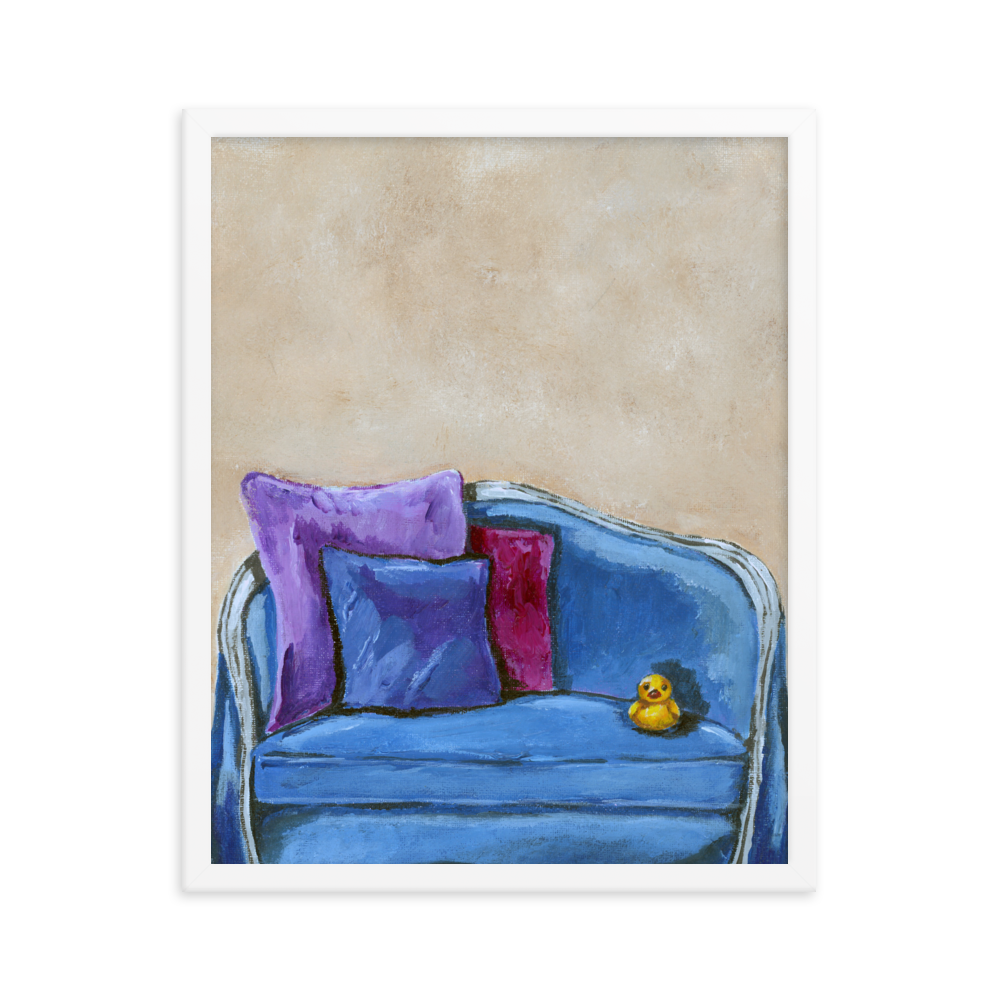 16x20 Framed print of a rubber duck sitting in a blue upholstered chair. Framed in white