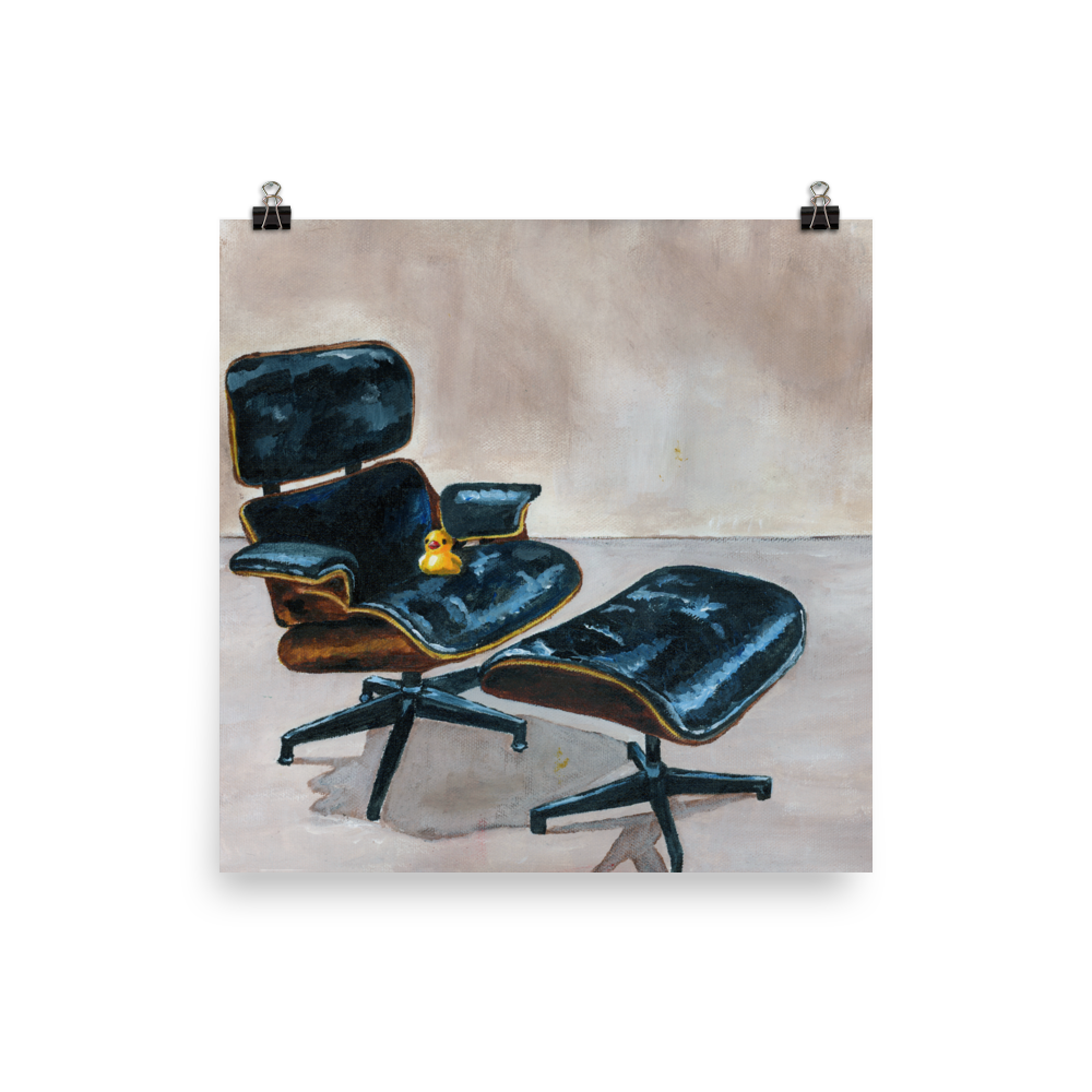 10x10 print of a rubber duck sitting in a black Eames chair.