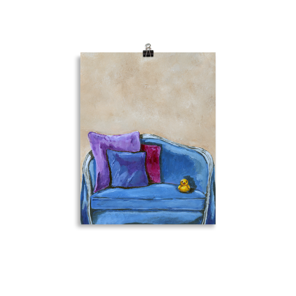 11x14 print of a rubber duck sitting in a blue upholstered chair.