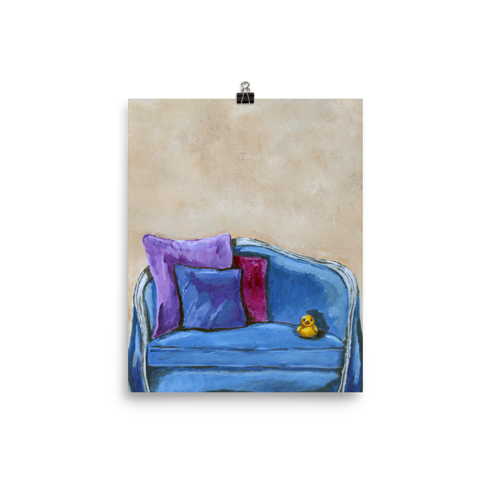 8x10 print of a rubber duck sitting in a blue upholstered chair.