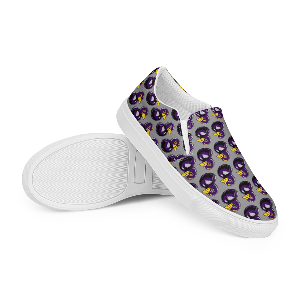 right over left side view of mens slip-on canvas shoes with a black and purple rubber duck logo pattern over gray background