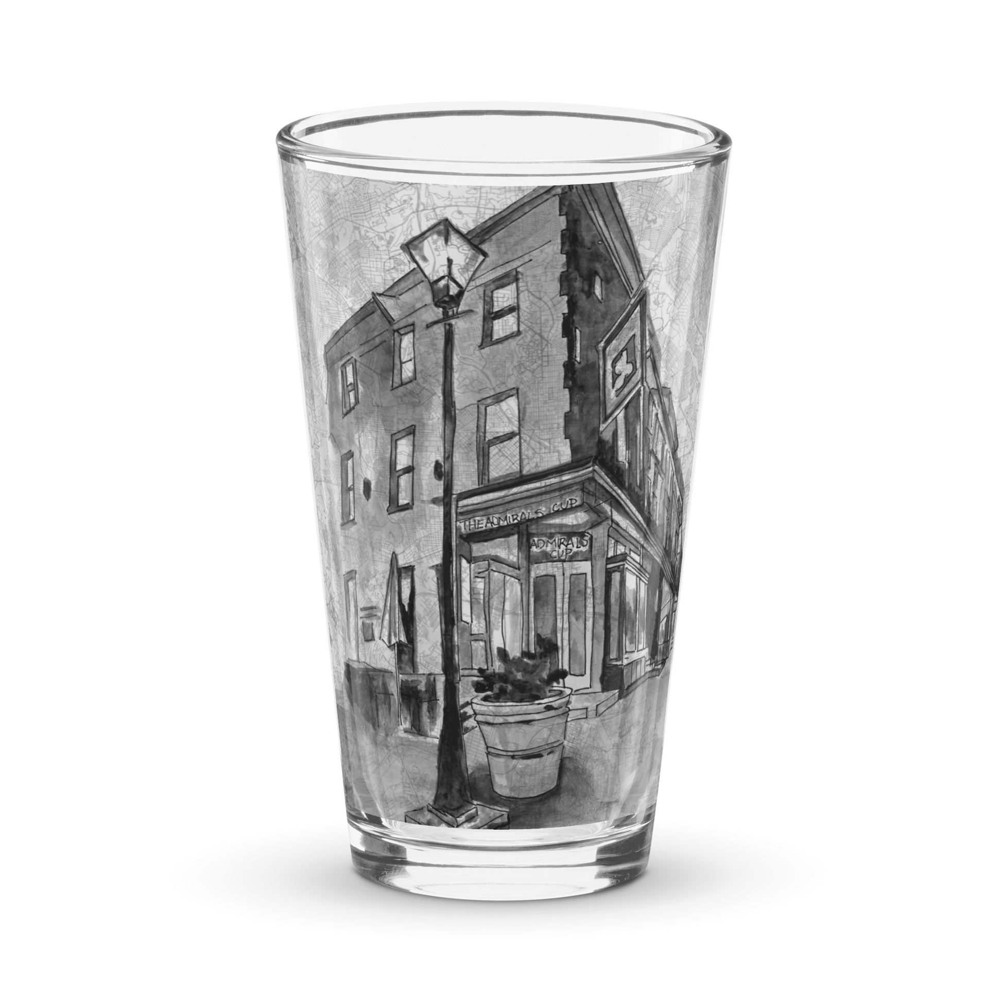 A picture of the front of a clear pint glass with the image of a watercolor painting of Baltimore's Admiral's Cup Bar painted on a map of the city