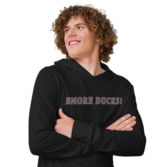 man with curly hair and arms crossed wearing a black BMORE DUCKS! football fan logo long sleeve hooded t-shirt